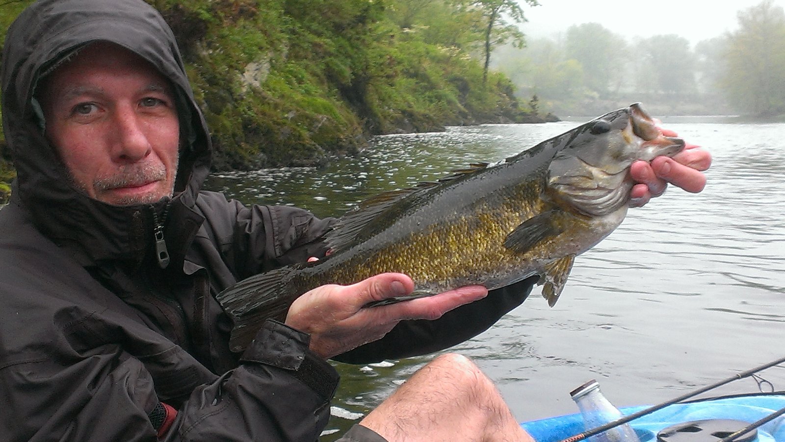 A large smallmouth bass held close to the camera.