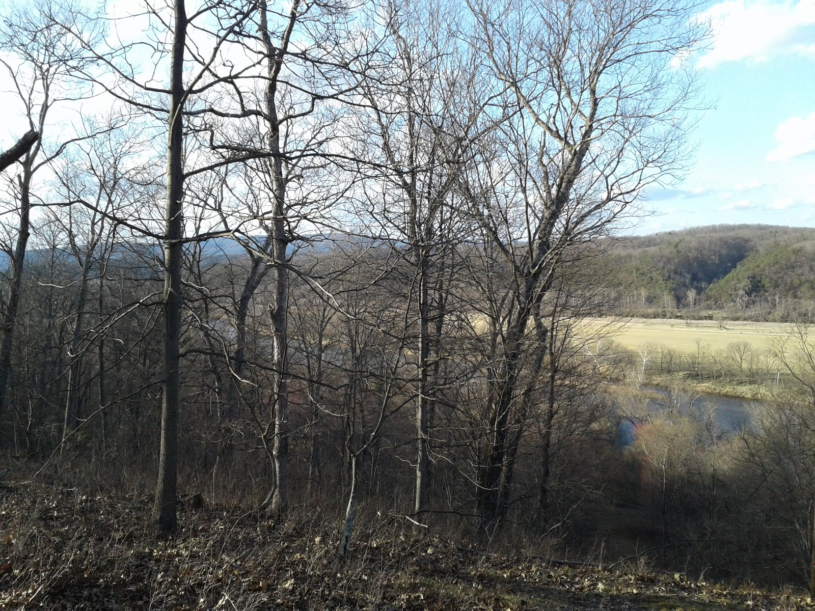 Looking out over a bare hillside toward the valley.