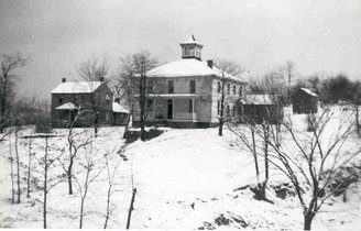 The Victor Smith homestead under snow, destroyed by a squatter's fire in the 1970s.