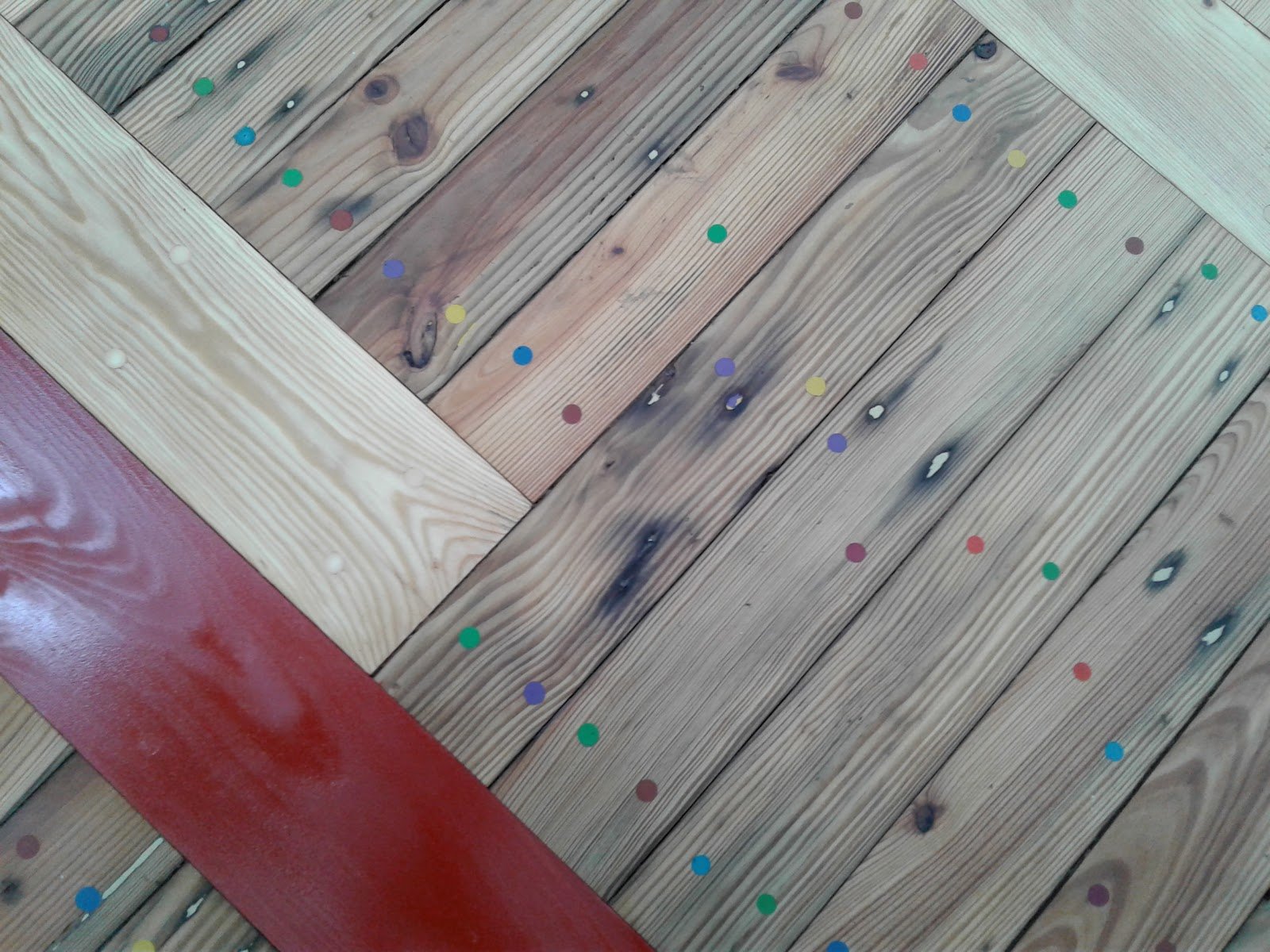 Close-up of the cork floor in violet and mint green checkerboard, with colorful painted dots.