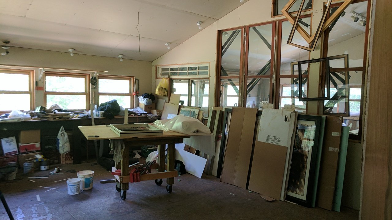 The raw, unfinished interior of the studio barn, a work table and materials waiting.